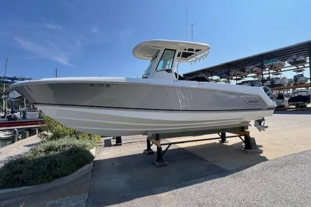 Slide: The Image of 2020 Boston Whaler 280 Outrage boat on display at a marina. - 3