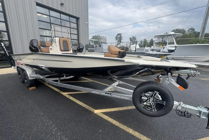 The Image of 2026 Xpress H22B Bay boat on trailer, parked outside a building. - 1
