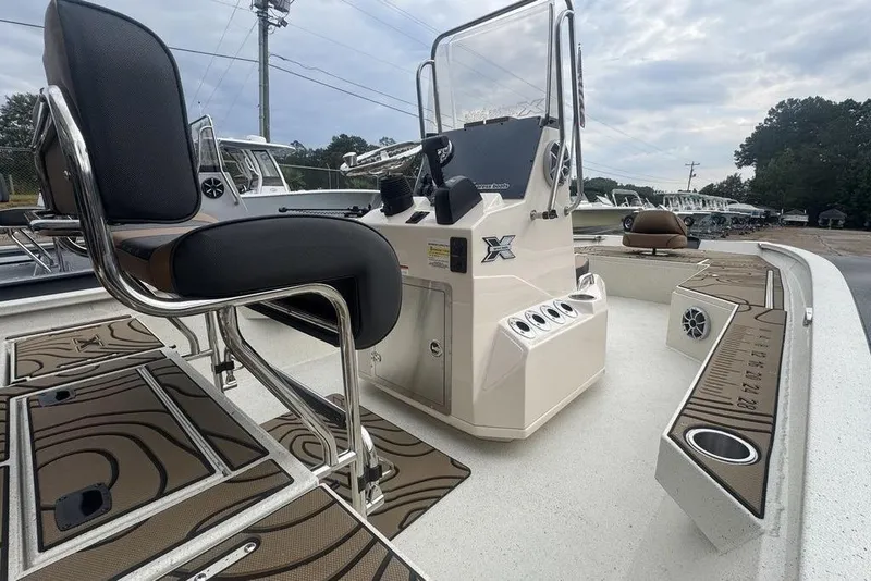 Slide: The Image of 2026 Xpress H22B Bay boat interior with seating and control console. - 10