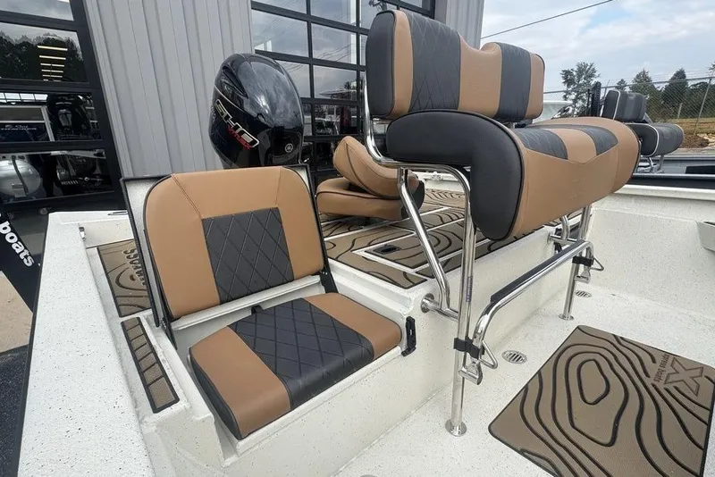 Slide: The Image of 2026 Xpress H22B Bay boat interior with stylish brown and black seating. - 14