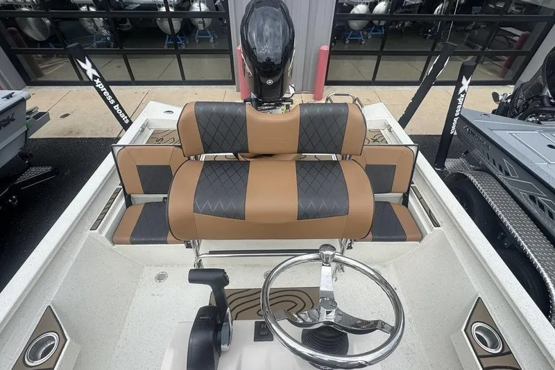 Slide: The Image of 2026 Xpress H22B Bay boat interior with stylish seating and steering wheel. - 17