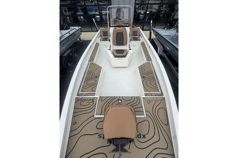 Slide: The Image of 2026 Xpress H22B Bay boat interior with brown and white seating and deck design. - 18