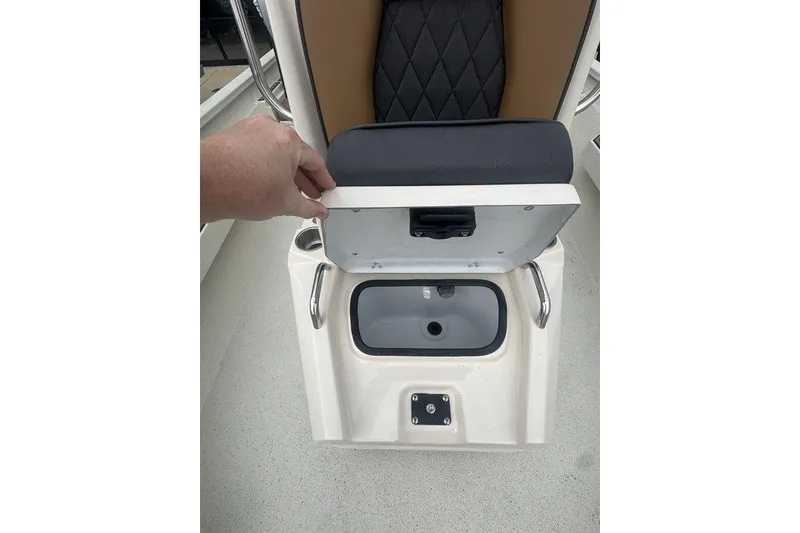 Slide: The Image of 2026 Xpress H22B Bay boat seat storage compartment with open lid, showcasing interior space. - 20