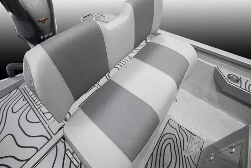 Slide: The Image of 2026 Xpress H22B Bay boat interior with gray and white seating and patterned flooring. - 22