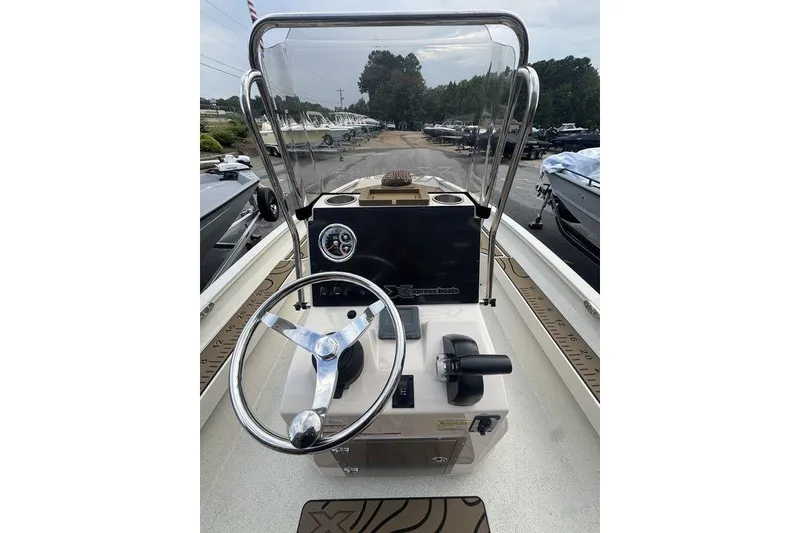 Slide: The Image of 2026 Xpress H22B Bay boat console with steering wheel and controls. - 23