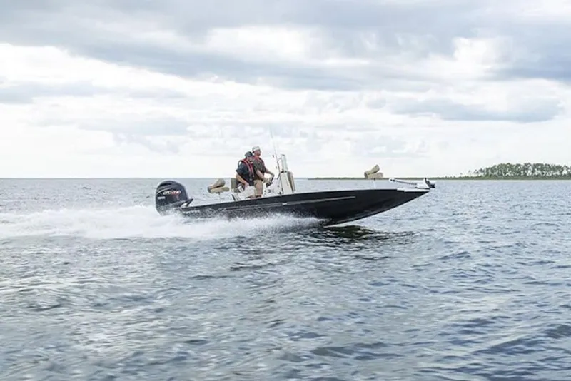 Slide: The Image of 2026 Xpress H22B Bay boat speeding on open water under cloudy skies. - 29