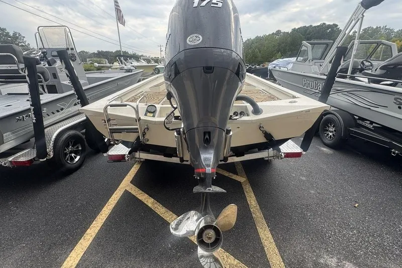 Slide: The Image of 2026 Xpress H22B Bay boat with 175 horsepower engine, parked on a trailer. - 4