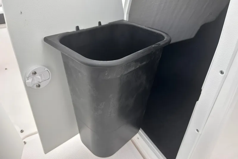 Slide: The Image of Built-in trash bin on 2025 Yamaha Boats AR190, showcasing interior storage feature. - 17