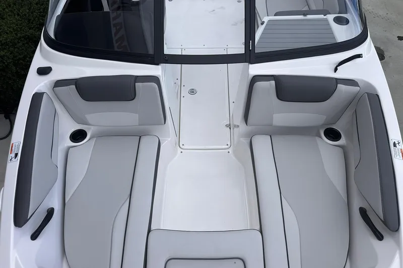 Slide: The Image of 2025 Yamaha Boats AR190 interior seating, featuring sleek gray and white upholstery design. - 19