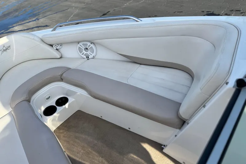 Slide: The Image of 2002 MasterCraft MariStar 230 VRS boat interior with cushioned seating and cup holders. - 10