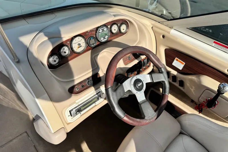 Slide: The Image of 2002 MasterCraft MariStar 230 VRS boat dashboard with gauges and steering wheel. - 24