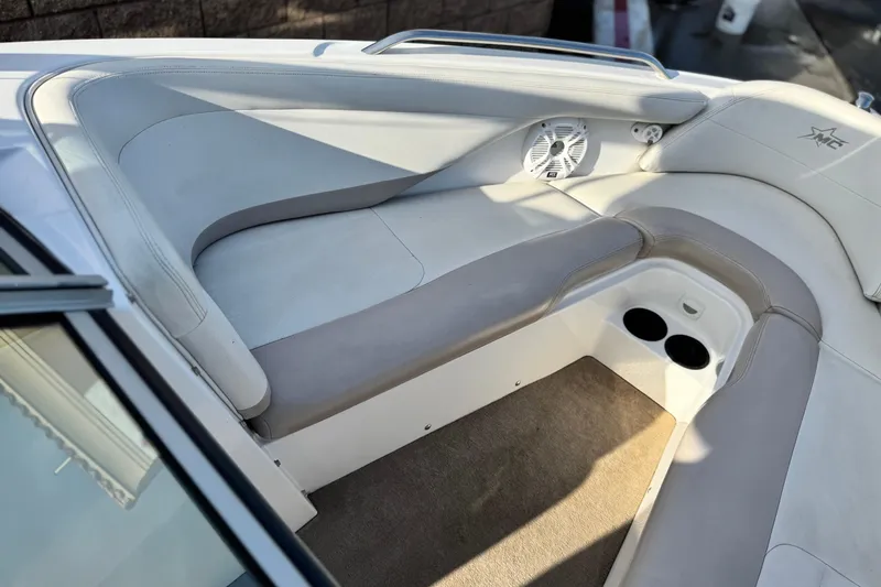 Slide: The Image of 2002 MasterCraft MariStar 230 VRS boat interior with cushioned seating and cup holders. - 9