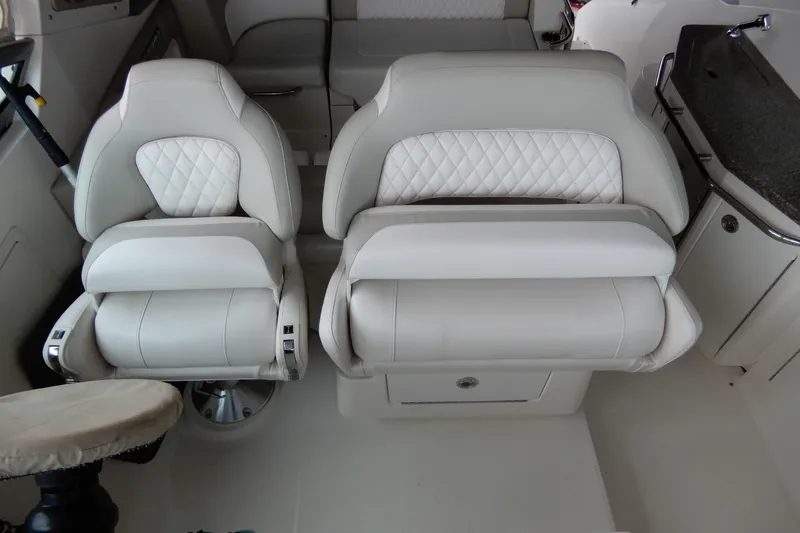 Slide: The Image of 2016 Chaparral 310 Signature boat interior with luxurious white seating and modern design. - 11
