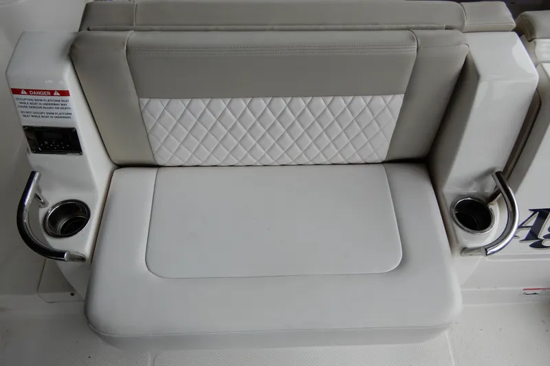 Slide: The Image of 2016 Chaparral 310 Signature boat seat with quilted design and cup holders. - 12