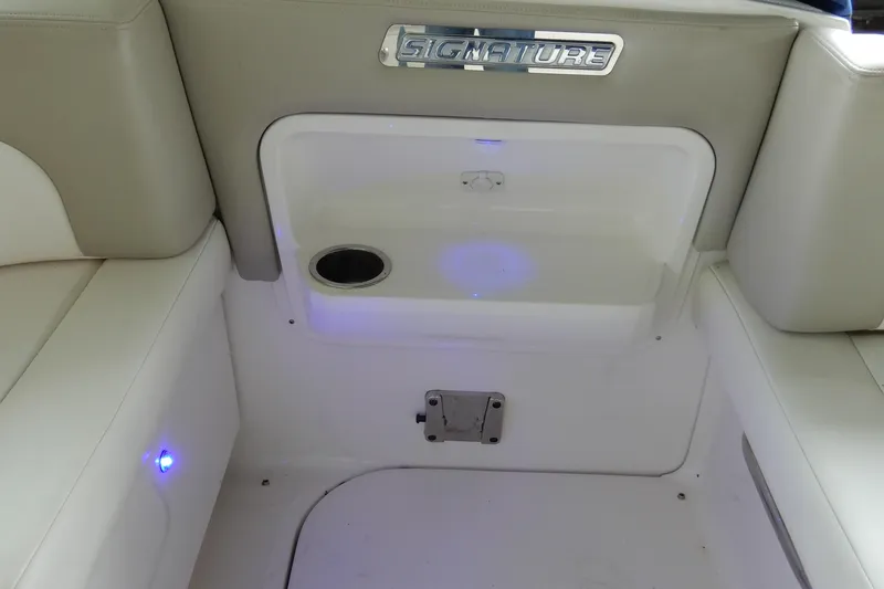 Slide: The Image of 2016 Chaparral 310 Signature boat interior with seating and storage compartment. - 14