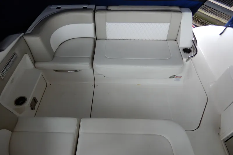 Slide: The Image of 2016 Chaparral 310 Signature boat interior with white seating and cup holders. - 15
