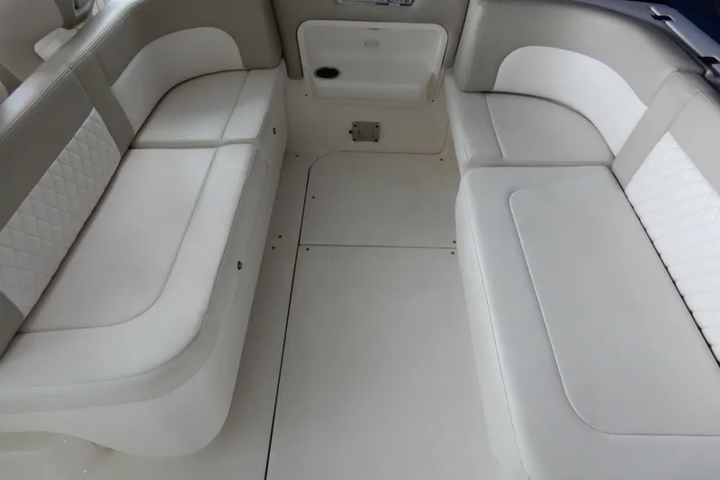 Slide: The Image of 2016 Chaparral 310 Signature boat interior with white cushioned seating. - 18