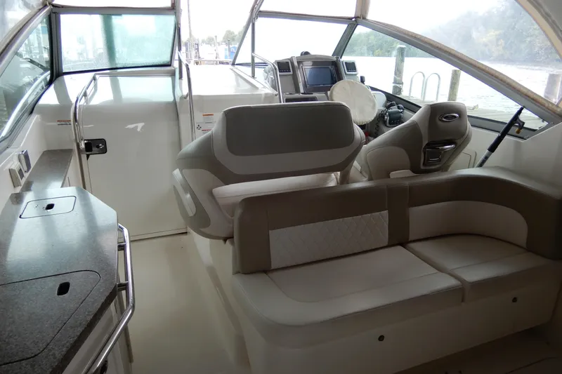 Slide: The Image of Interior of 2016 Chaparral 310 Signature boat with seating and helm station. - 19