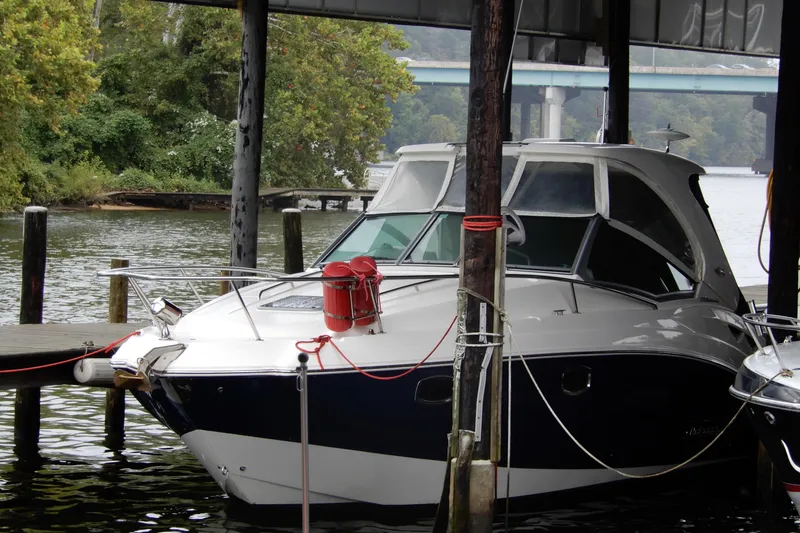 Slide: The Image of 2016 Chaparral 310 Signature boat docked under a covered marina. - 2