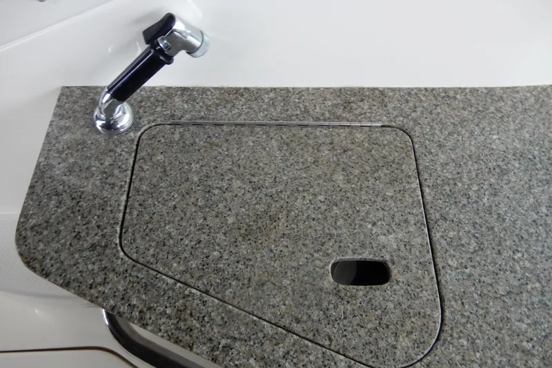 Slide: The Image of Granite countertop with sink cover on 2016 Chaparral 310 Signature boat. - 21