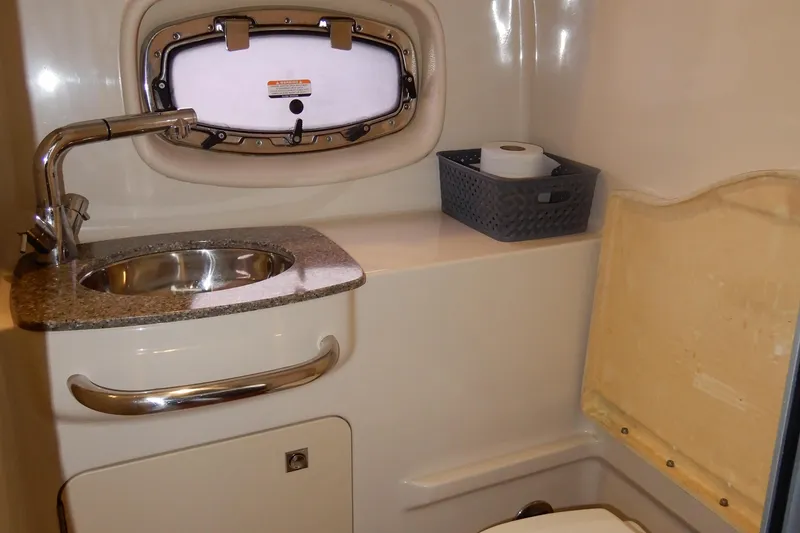 Slide: The Image of 2016 Chaparral 310 Signature boat bathroom with sink, faucet, and storage basket. - 37