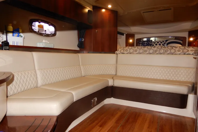 Slide: The Image of Luxurious interior of 2016 Chaparral 310 Signature boat with plush seating and wooden flooring. - 38