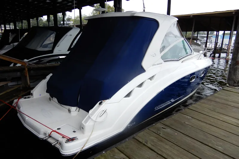 Slide: The Image of 2016 Chaparral 310 Signature boat docked with blue cover in marina. - 4