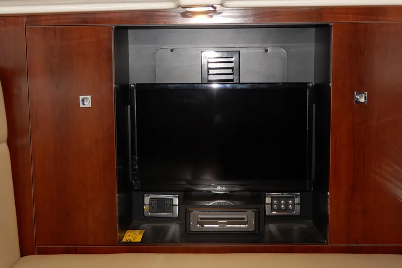 Slide: The Image of Entertainment system in 2016 Chaparral 310 Signature boat with TV and controls. - 43