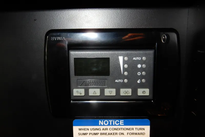 Slide: The Image of Control panel of a 2016 Chaparral 310 Signature boat with air conditioning notice. - 45
