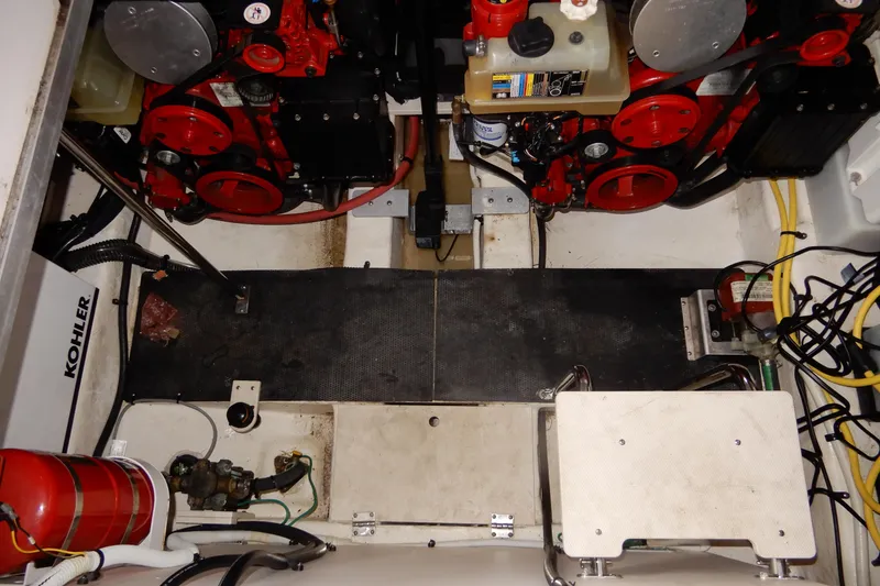 Slide: The Image of Engine compartment of a 2016 Chaparral 310 Signature boat, featuring dual engines and equipment. - 48