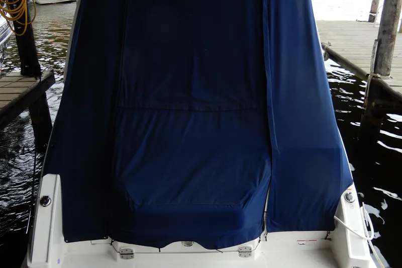 Slide: The Image of 2016 Chaparral 310 Signature boat with blue cover docked at marina. - 5