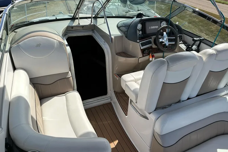 Slide: The Image of 2006 Four Winns 318 Vista boat interior with leather seating and modern dashboard. - 1