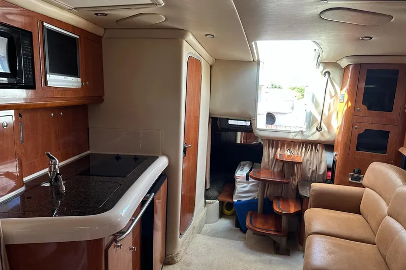 Slide: The Image of Interior of 2006 Four Winns 318 Vista boat with kitchen and seating area. - 7