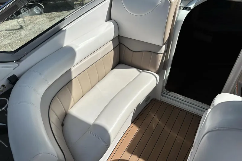 Slide: The Image of 2006 Four Winns 318 Vista boat interior with beige leather seating and wood flooring. - 8