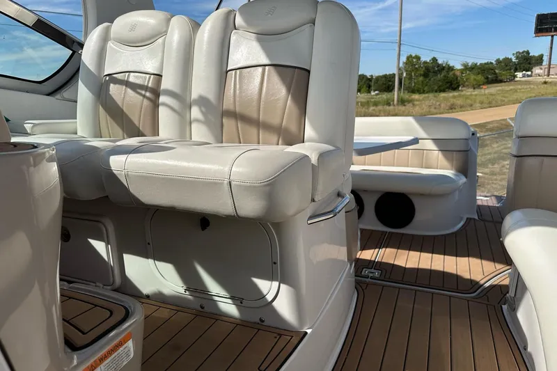 Slide: The Image of 2006 Four Winns 318 Vista boat interior with beige leather seating and wood flooring. - 9