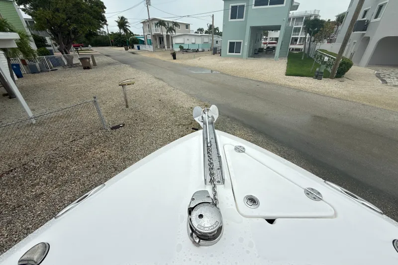 Slide: The Image of Bow of 2016 Everglades 295 Center Console boat with anchor chain, residential street view. - 19