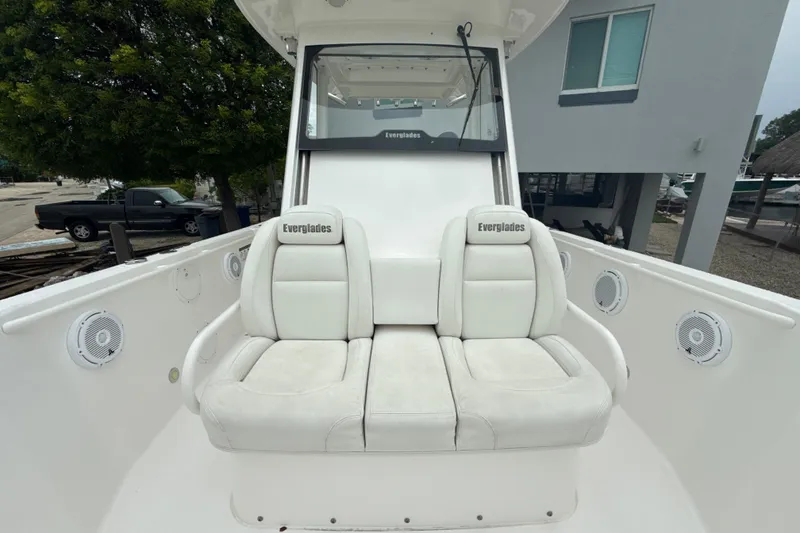 Slide: The Image of 2016 Everglades 295 Center Console boat with white seating and speakers. - 21
