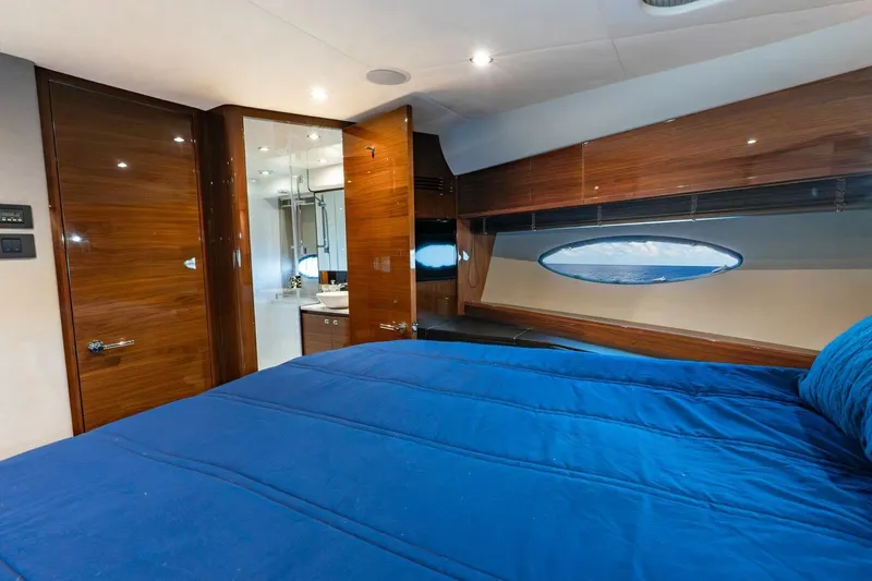 Slide: The Image of Luxurious cabin interior of 2015 Princess 56 Flybridge Yacht with blue bedding and wood finish. - 12