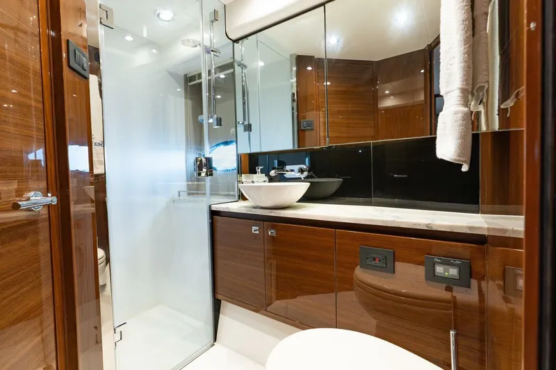 Slide: The Image of Luxurious bathroom in 2015 Princess 56 Flybridge Motor Yacht with modern fixtures and wood accents. - 13