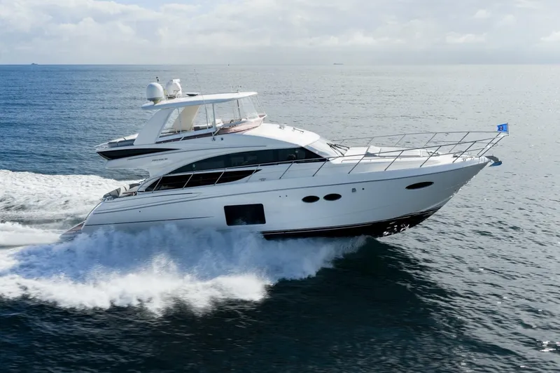 The Image of 2015 Princess 56 Flybridge Motor Yacht cruising on open water. - 2
