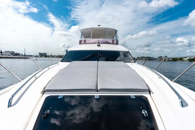 Slide: The Image of 2015 Princess 56 Flybridge Motor Yacht on calm water under a blue sky. - 20