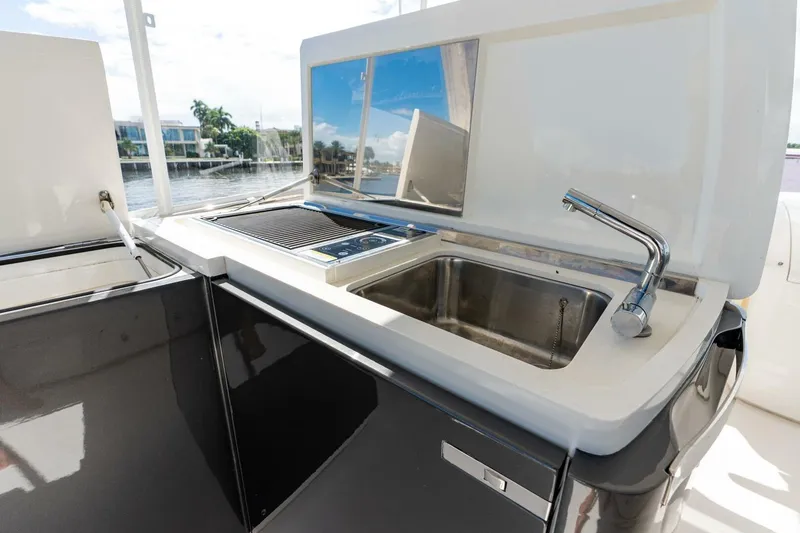 Slide: The Image of Outdoor kitchen on 2015 Princess 56 Flybridge Motor Yacht with sink and grill. - 23