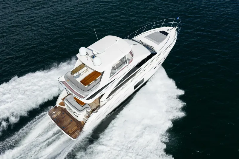 Slide: The Image of 2015 Princess 56 Flybridge Motor Yacht cruising on open water, aerial view. - 3