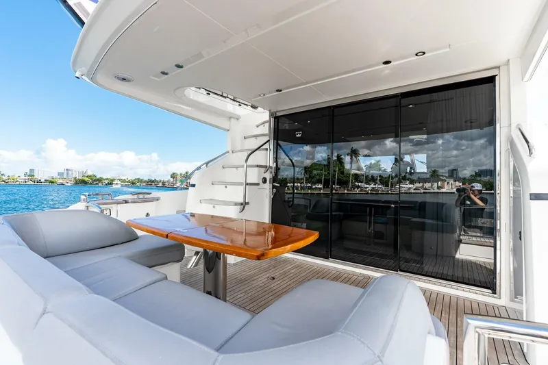 Slide: The Image of Luxurious 2015 Princess 56 Flybridge Motor Yacht with elegant outdoor seating and scenic water views. - 30