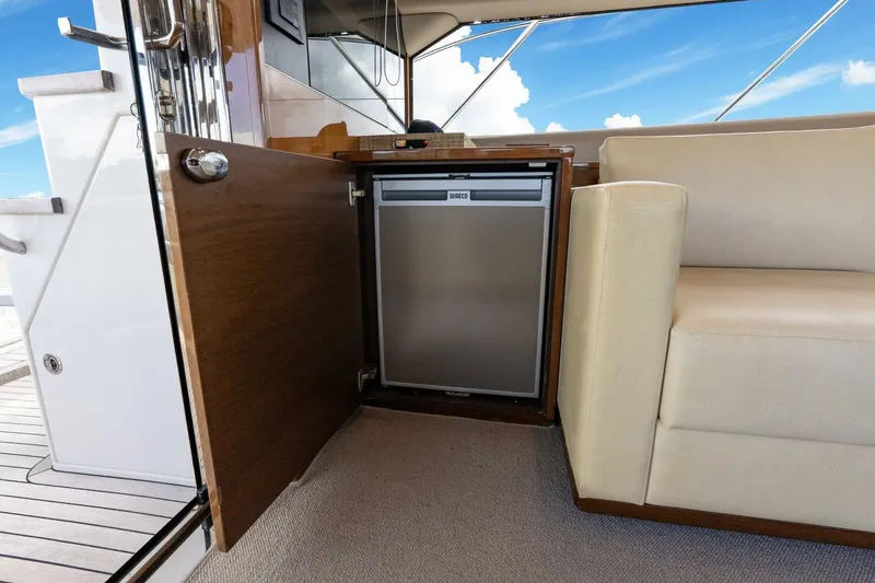 Slide: The Image of Luxurious interior of 2015 Princess 56 Flybridge Yacht with built-in fridge and seating. - 32