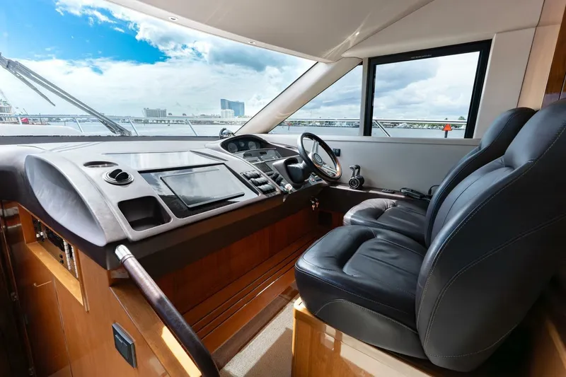 Slide: The Image of Interior helm of 2015 Princess 56 Flybridge Motor Yacht with leather seats and modern controls. - 38