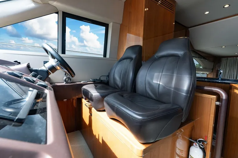 Slide: The Image of Interior of 2015 Princess 56 Flybridge Yacht with leather seats and steering wheel. - 39
