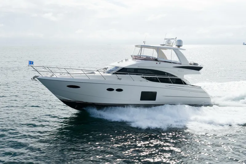 Slide: The Image of 2015 Princess 56 Flybridge Motor Yacht cruising on open water. - 7