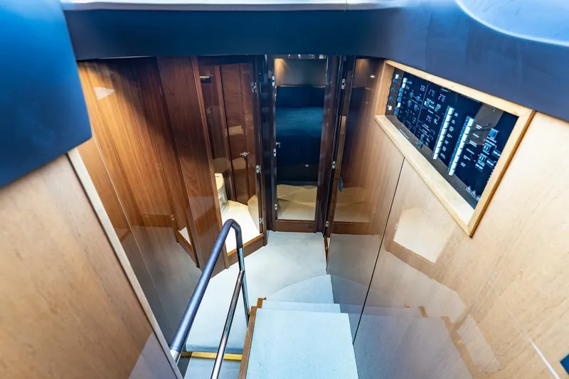 Slide: The Image of Interior view of 2015 Princess 56 Flybridge Motor Yacht, featuring wooden paneling and control panel. - 8