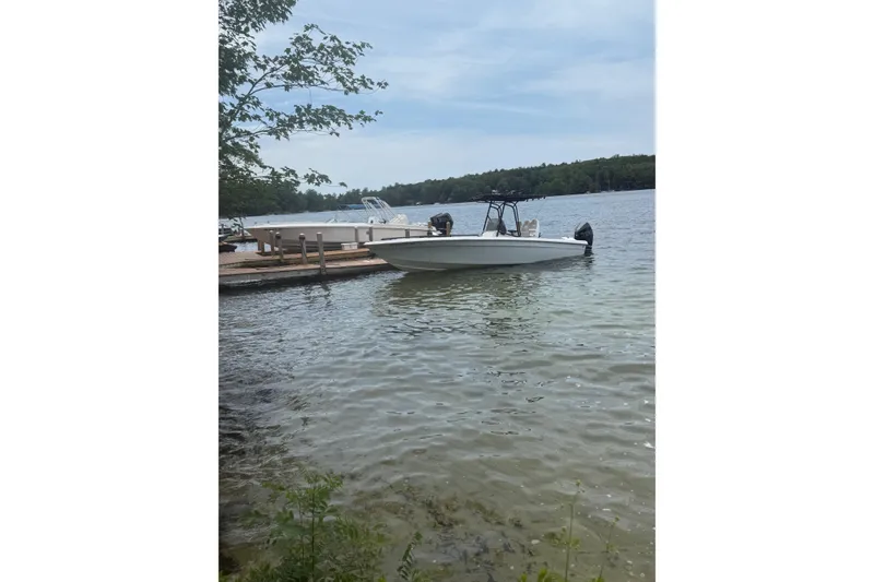 Slide: The Image of Boat docked on a calm lake, surrounded by trees, Concept 27 model, 2004. - 13
